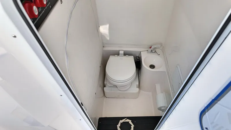  Yacht Photos Pics Compact bathroom in 2022 Fountain 38TE boat with toilet and sink.