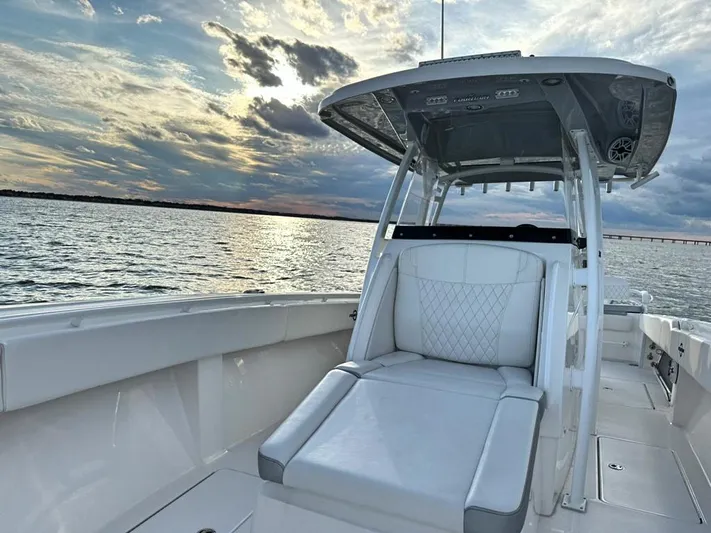  Yacht Photos Pics 2022 Fountain 38TE boat on water at sunset, featuring sleek seating and modern design.