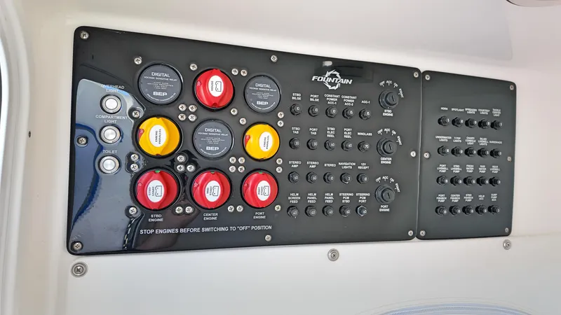  Yacht Photos Pics Control panel of a 2022 Fountain 38TE boat with labeled switches and buttons.