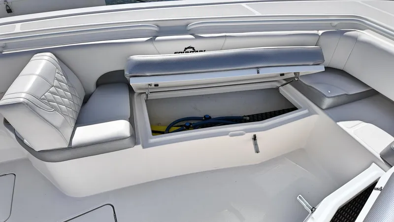  Yacht Photos Pics 2022 Fountain 38TE boat interior with open storage compartment and cushioned seating.