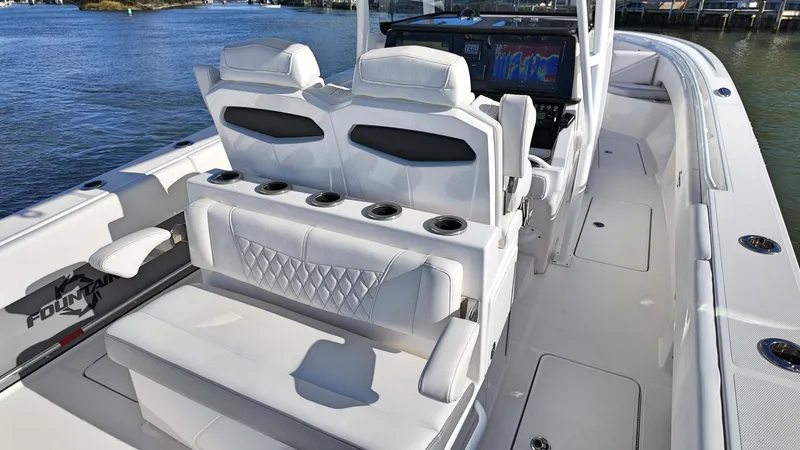  Yacht Photos Pics 2022 Fountain 38TE boat interior with white seating and modern dashboard.