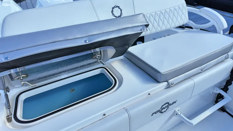  Yacht Photos Pics 2022 Fountain 38TE boat interior with open storage compartment and cushioned seating.