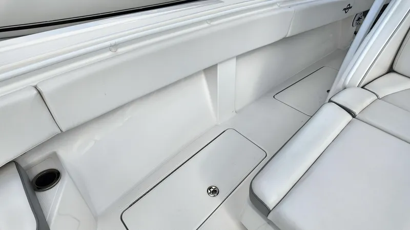  Yacht Photos Pics Interior view of 2022 Fountain 38TE boat, featuring sleek white seating and storage compartments.