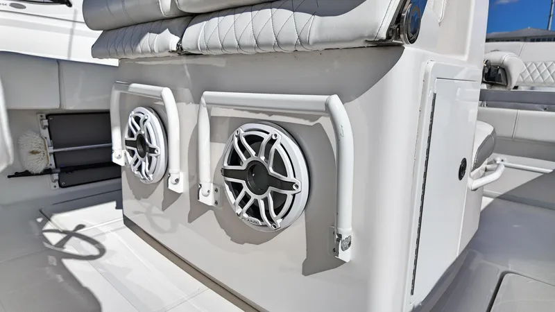  Yacht Photos Pics 2022 Fountain 38TE boat interior with dual speakers and cushioned seating.