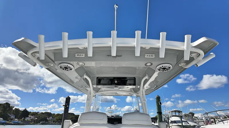  Yacht Photos Pics 2022 Fountain 38TE boat with rod holders and speakers, under a clear blue sky.