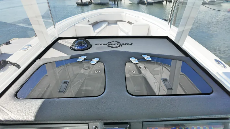  Yacht Photos Pics 2022 Fountain 38TE boat dashboard with dual compartments, sleek design, and water view.