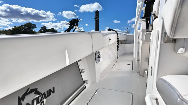  Yacht Photos Pics 2022 Fountain 38TE boat interior with white seating and clear blue sky.