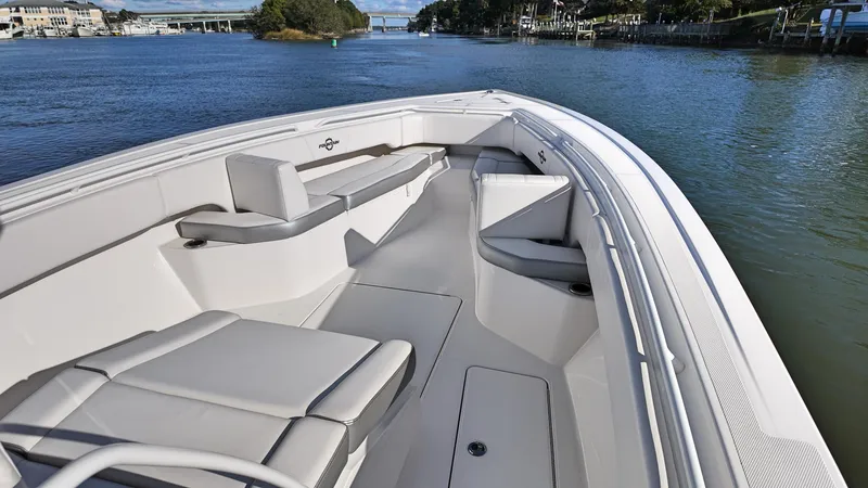  Yacht Photos Pics 2022 Fountain 38TE boat with spacious seating on a calm waterway.