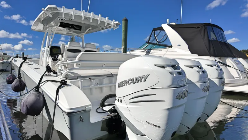  Yacht Photos Pics 2022 Fountain 38TE boat with triple Mercury 400 engines docked in marina.