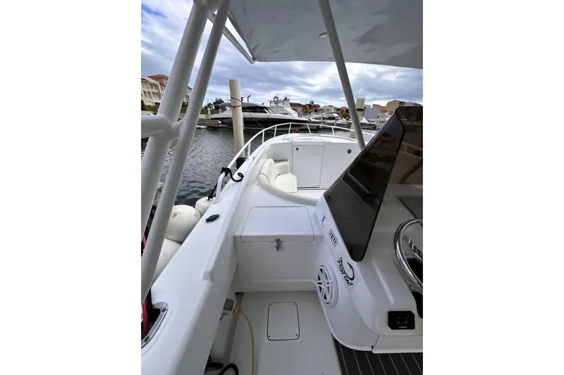  Yacht Photos Pics 1996 Itrepid 35 Cuddy boat interior, docked with other vessels in the background.