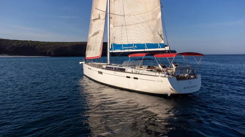 Ayacucho Yacht Photos Pics Sailing yacht Hanse 630E (2008) on calm sea with clear blue sky.