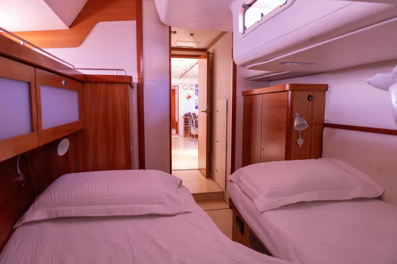 Ayacucho Yacht Photos Pics Interior of 2008 Hanse 630E yacht with twin beds and wooden cabinetry.