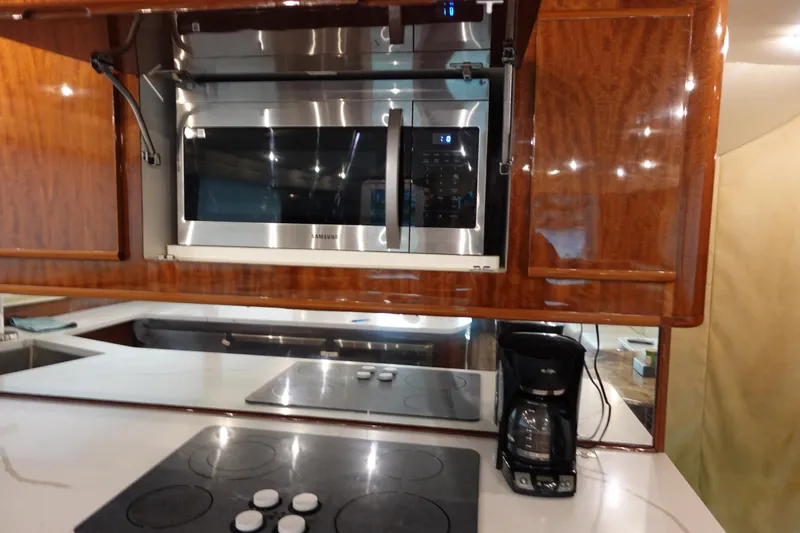  Yacht Photos Pics Kitchen area of 1988 Donzi Z-65 Tournament Fisherman with microwave, stovetop, and coffee maker.