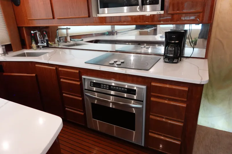  Yacht Photos Pics 1988 Donzi Z-65 Tournament Fisherman yacht kitchen with modern appliances and wooden cabinetry.