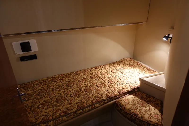  Yacht Photos Pics 1988 Donzi Z-65 Tournament Fisherman cabin with patterned bedding and cozy lighting.