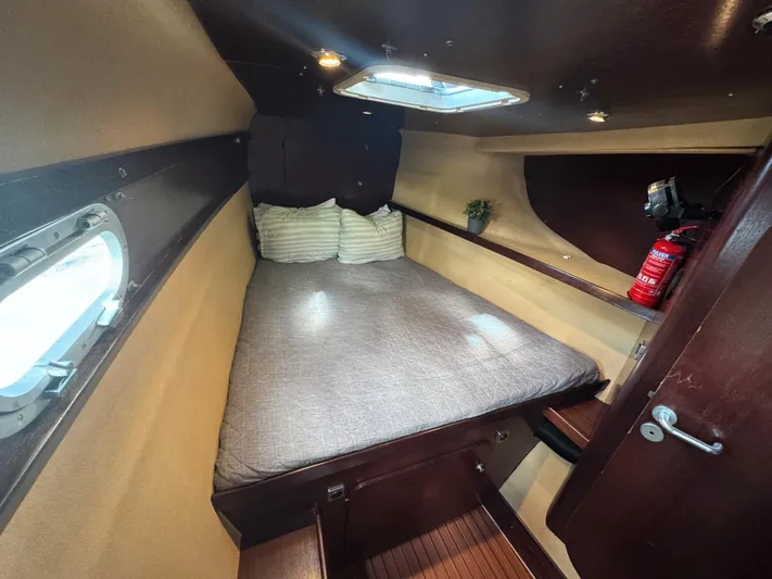 Savannah Yacht Photos Pics Cozy cabin interior of 1998 Fountaine Pajot Bahia 46 catamaran with bed and porthole.