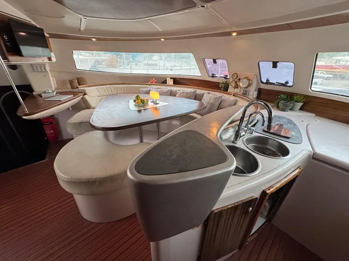 Savannah Yacht Photos Pics Luxurious interior of 1998 Fountaine Pajot Bahia 46 catamaran with modern kitchen and seating area.