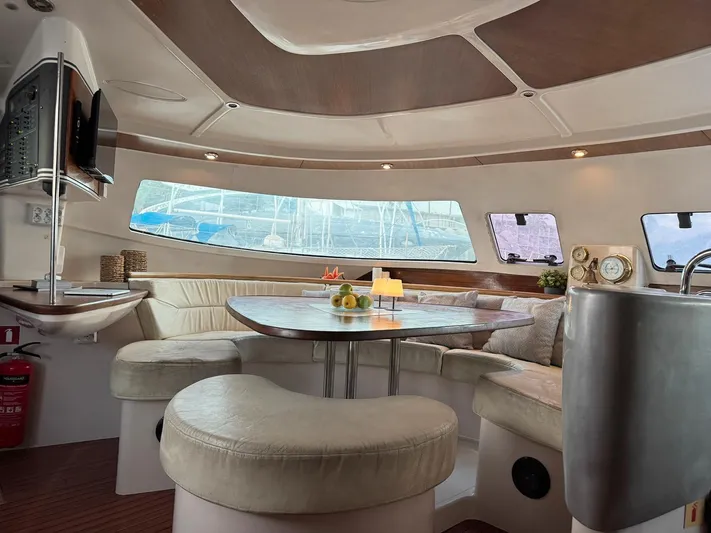 Savannah Yacht Photos Pics Luxurious interior of 1998 Fountaine Pajot Bahia 46 catamaran with elegant seating and dining area.