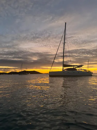 Savannah Yacht Photos Pics Sailing catamaran Fountaine Pajot Bahia 46 at sunset, tranquil waters, 1998 model.