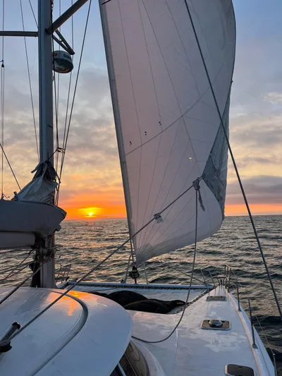 Savannah Yacht Photos Pics Sailing on a 1998 Fountaine Pajot Bahia 46 at sunset, ocean view.