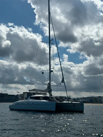 Savannah Yacht Photos Pics Sailing catamaran Fountaine Pajot Bahia 46, 1998 model, on calm waters under cloudy sky.