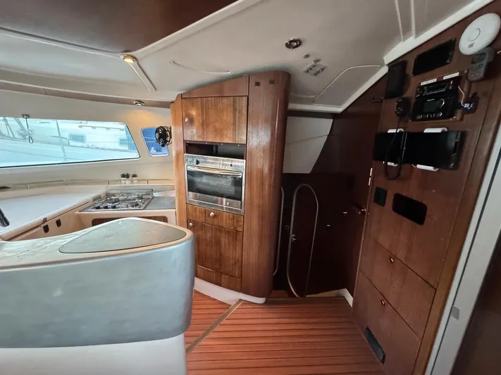 Savannah Yacht Photos Pics Interior of 1998 Fountaine Pajot Bahia 46 catamaran with wood paneling and modern kitchen appliances.