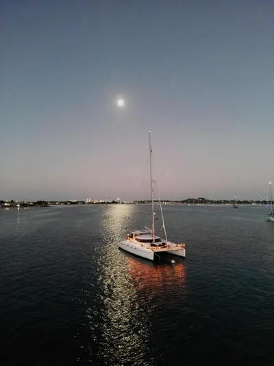 Savannah Yacht Photos Pics Sailing catamaran Fountaine Pajot Bahia 46, 1998, under moonlight on calm waters.