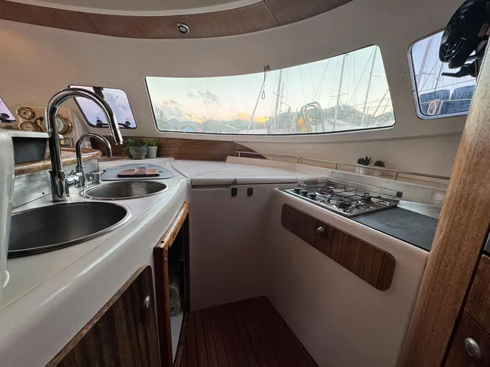 Savannah Yacht Photos Pics Interior of 1998 Fountaine Pajot Bahia 46 catamaran kitchen with sink and stove.