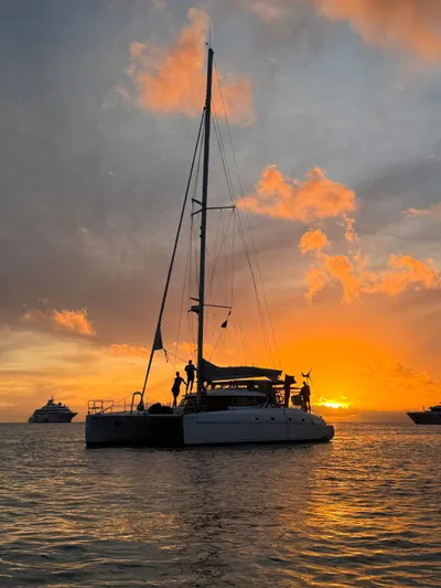 Savannah Yacht Photos Pics Sailing catamaran Fountaine Pajot Bahia 46 at sunset, 1998 model, on tranquil waters.