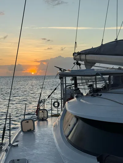 Savannah Yacht Photos Pics Fountaine Pajot Bahia 46 sailing at sunset, 1998 model, ocean view.