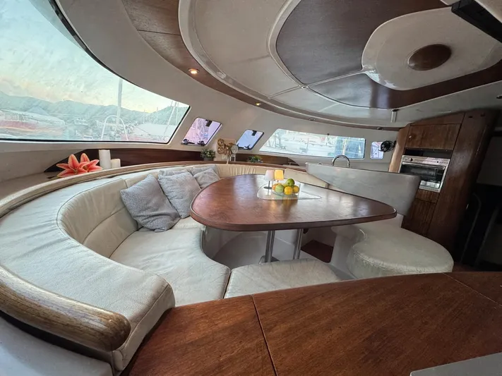 Savannah Yacht Photos Pics Luxurious interior of 1998 Fountaine Pajot Bahia 46 catamaran with elegant seating and dining area.