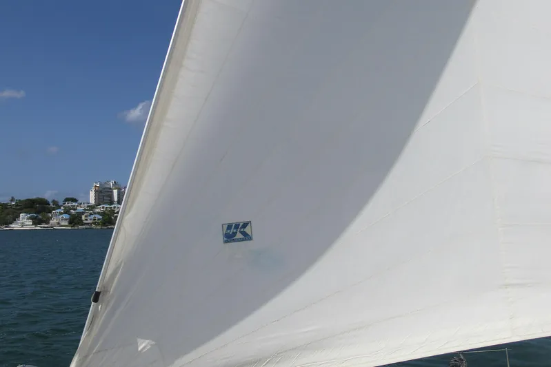 Savannah Yacht Photos Pics Sail of a 1998 Fountaine Pajot Bahia 46 catamaran against a coastal backdrop.