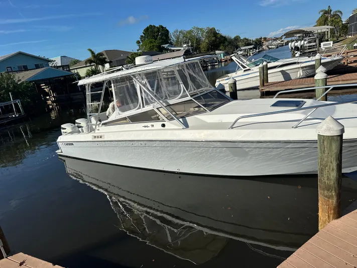  Yacht Photos Pics 2001 Contender 35 Side Console boat docked in a marina under clear skies.
