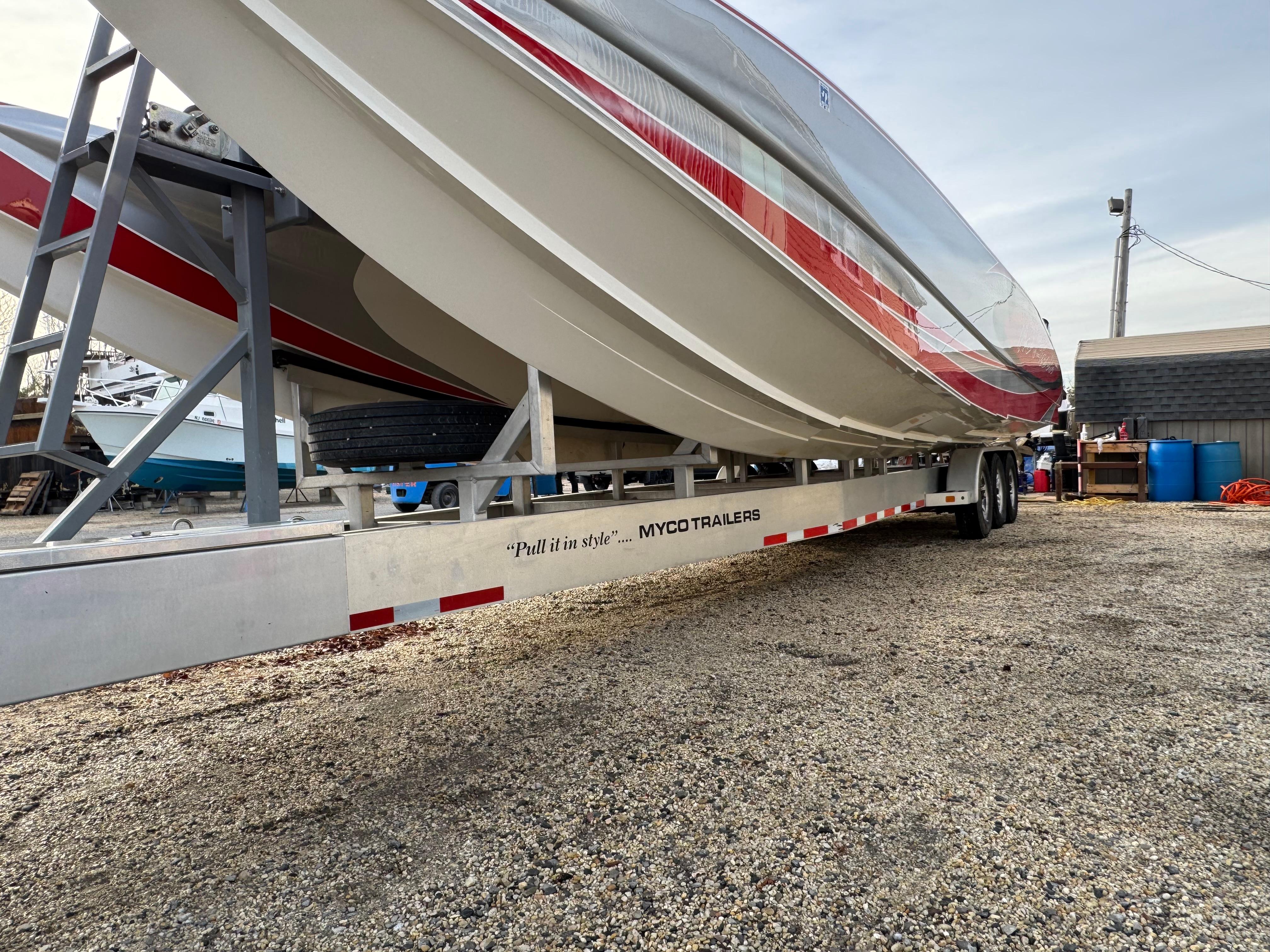 2010 Nor-Tech 4000 Roadster boat on Myco trailer, parked on gravel.