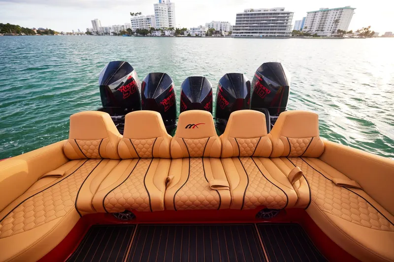 Yacht Photos Pics Luxurious seating on 2024 Midnight Express 43' Solstice boat with powerful engines, cityscape in background.