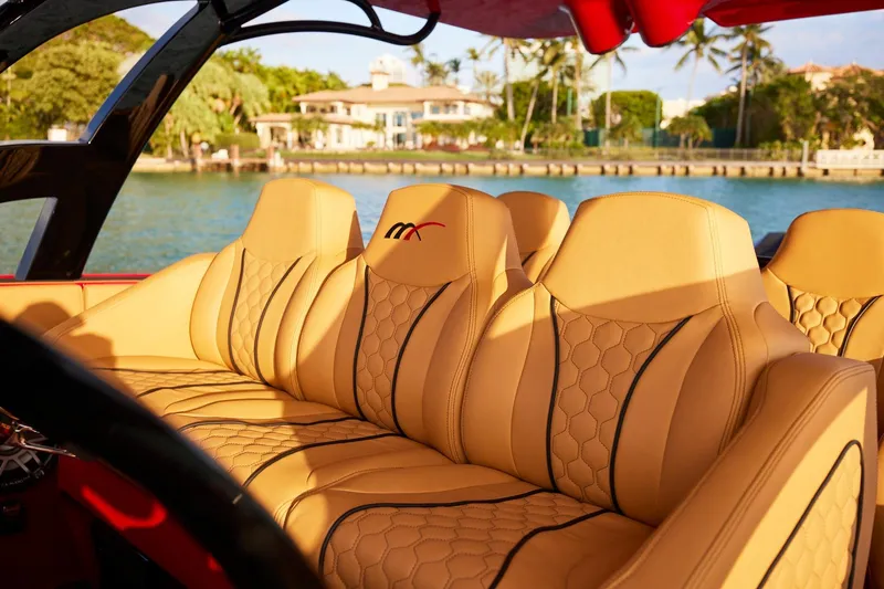  Yacht Photos Pics Luxurious tan seating on 2024 Midnight Express 43' Solstice boat, with scenic waterfront view.