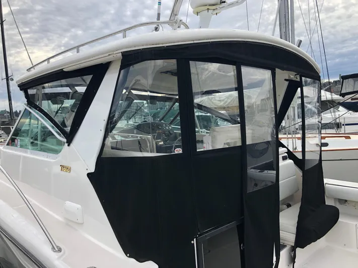  Yacht Photos Pics 2003 Tiara Yachts 3500 Open with black canvas enclosure at marina.