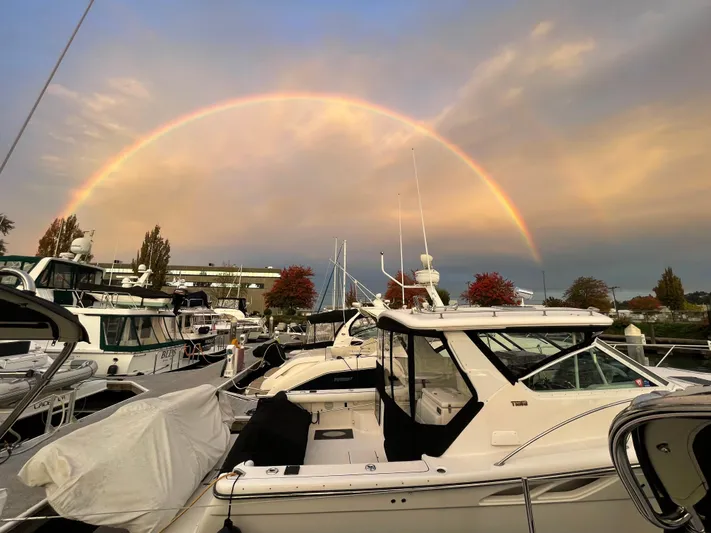  Yacht Photos Pics A 2003 Tiara Yachts 3500 Open docked under a vibrant rainbow at sunset.