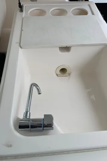  Yacht Photos Pics 2003 Tiara Yachts 3500 Open sink with chrome faucet and cutting board.