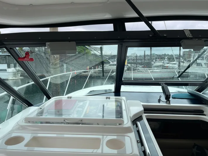  Yacht Photos Pics Interior view of 2003 Tiara Yachts 3500 Open, showcasing helm and marina backdrop.