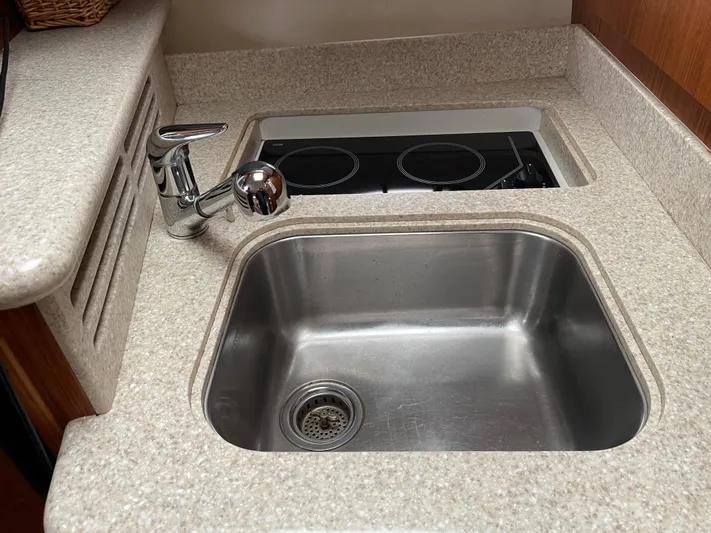  Yacht Photos Pics 2003 Tiara Yachts 3500 Open kitchen sink and stove in compact galley area.