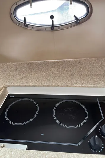  Yacht Photos Pics 2003 Tiara Yachts 3500 Open kitchen with electric stove and porthole window.