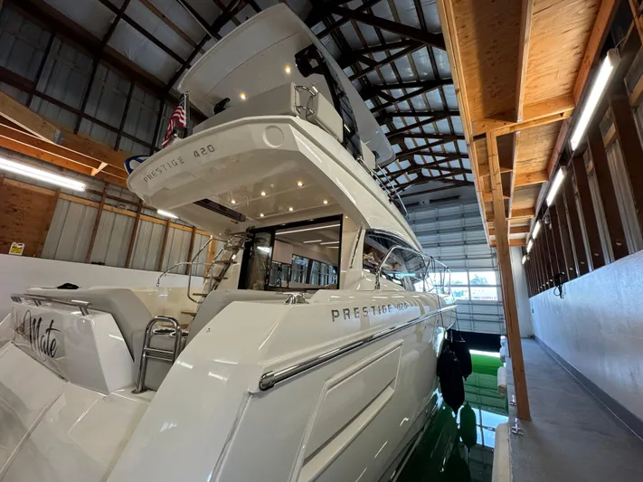  Yacht Photos Pics 2020 Prestige 420 yacht docked in a covered marina, showcasing sleek design and luxury features.