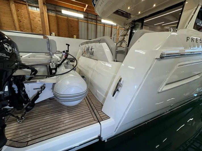  Yacht Photos Pics Prestige 420 yacht, 2020 model, docked indoors with outboard motor and wooden deck.