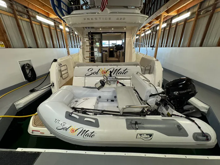  Yacht Photos Pics Prestige 420 yacht with inflatable boat "Sol Mate" in a covered dock, 2020 model.