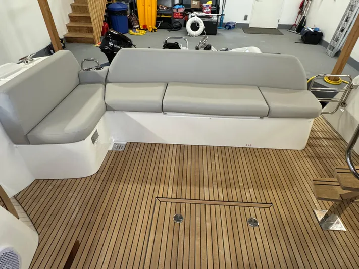  Yacht Photos Pics 2020 Prestige 420 yacht interior with gray seating and wooden flooring.