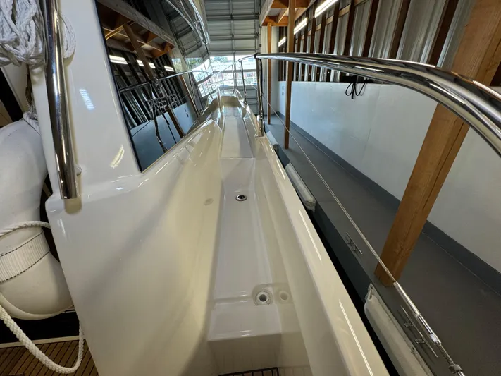  Yacht Photos Pics Side deck of a 2020 Prestige 420 yacht in a covered marina.