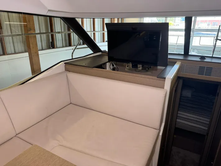  Yacht Photos Pics Luxurious interior of 2020 Prestige 420 yacht with retractable TV and comfortable seating.