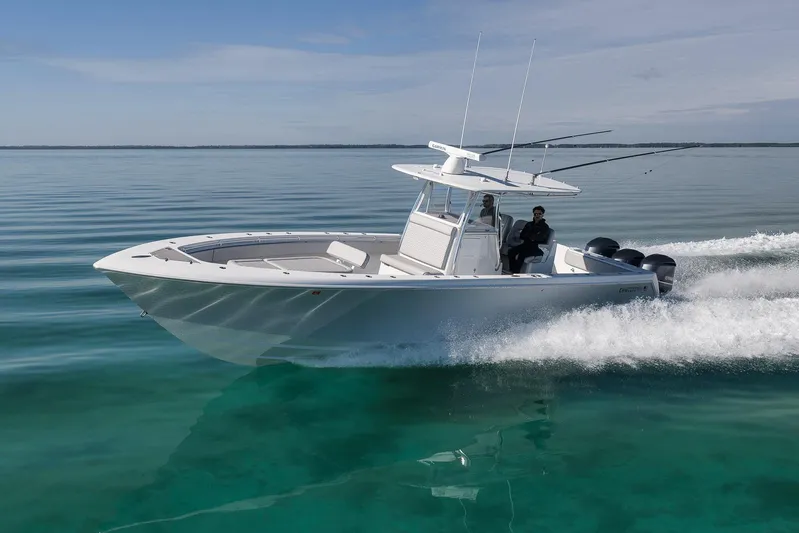  Yacht Photos Pics 2021 Contender 39 ST boat cruising on clear, calm waters under a blue sky.