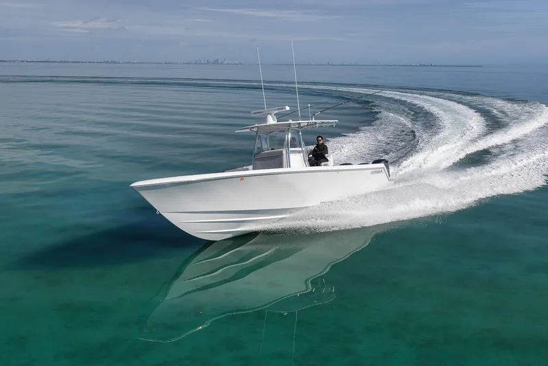  Yacht Photos Pics 2021 Contender 39 ST boat cruising on clear, calm waters.